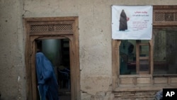 A woman leaves a Shiite shrine in a predominantly Hazara neighborhood in Kabul, Nov. 9, 2021. 