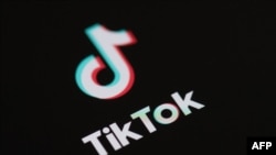 (FILES) This illustration picture taken on May 27, 2020 in Paris shows the logo of the social network application Tik Tok on the screen of a phone.