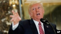 President Donald Trump speaks to the media in the lobby of Trump Tower in New York, Aug. 15, 2017. 