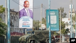 FILE - Security forces block a street with an armored personnel carrier during protests against the government and the delay of the country's election in the capital, Mogadishu, Somalia, Feb. 19, 2021.