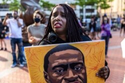 A woman reacts as she marches during an event in remembrance of George Floyd in Minneapolis, Minnesota, on May 23, 2021.