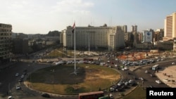 Egypt's national flag is seen raised at the top of a flag pole, which was recently installed in Tahrir square, in central Cairo, Feb. 8, 2015. 