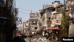A general view shows buildings that were damaged during clashes between with forces loyal to Syria's President Bashar al-Assad and Free Syrian Army fighters, near Sayeda Zainab area in Damascus, May 27, 2013. 