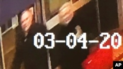 In this image taken from security camera footage from PA shows a man and woman as they walk through an alleyway connecting a Zizzi's restaurant to a bench where former Russian double agent Sergei Skripal was found in Salisbury, March 4, 2018. The image is believed to be of interest to police.