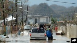 Residents evacuate after the passing of Hurricane Maria, in Toa Baja, Puerto Rico, Sept. 22, 2017.