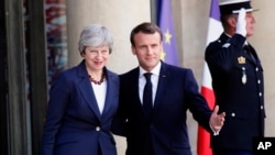 French President Emmanuel Macron, right, and British Prime Minister Theresa May pose before a meeting at the Elysee Palace in Paris, France, April 9, 2019.
