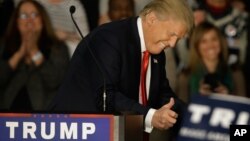 FILE - Republican presidential candidate Donald Trump smiles and gives a thumbs up as supporters applaud during a campaign rally Nov. 9, 2015, in Springfield, Illinois.