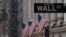 FILE - The Wall Street sign is pictured in front of the New York Stock Exchange in New York City.