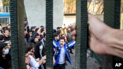 FILE - University students attend an anti-government protest at Iran's Tehran University, Dec. 30, 2017. The photo, obtained by the Associated Press, was taken by an individual not employed by AP. 
