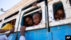 Refugees who fled the conflict in Ethiopia's Tigray region ride a bus going to the Village 8 temporary shelter, near the Sudan-Ethiopia border, in Hamdayet, eastern Sudan, Dec. 1, 2020. 