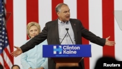 Democratic U.S. presidential candidate Hillary Clinton listens to her choice for running mate, Senator Tim Kaine of Virginia, after she introduced him during a campaign rally in Miami, Florida, July 23, 2016.