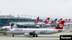 FILE - A Turkish Airlines plane prepares to take off at Ataturk International Airport in Istanbul, May 15, 2013. Turkey has deported some of eight Moroccans detained and questioned on arrival at Istanbul's main airport over suspected militant links, a Turkish government official said.
