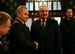 Commander of the Libyan National Army (LNA) Khalifa Haftar shakes hands with Russian Defense Minister Sergei Shoigu before talks in Moscow, Jan. 13, 2020. (Ministry of Foreign Affairs of the Russian Federation/Handout via Reuters)