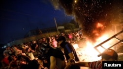 Demonstrators gather at a protest during a curfew, two days after the nationwide anti-government protests turned violent, in Baghdad, Oct. 3, 2019. 