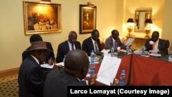 FILE - Negotiators at South Sudan peace talks in Addis Ababa review a draft cessation of hostilities agreement, Jan. 13, 2014.