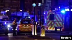 Police attend to an incident on the London Bridge in London, June 3, 2017.