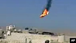 This citizen journalism image purports to show a Syrian military helicopter on fire and falling to the ground after it was apparently hit during fighting between government forces and rebels in Damascus, Aug 27, 2012. AP IS UNABLE TO INDEPENDENTLY VERIFY 