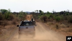 FILE - Anti-rhino poaching troops simulate a hunt for poachers in the Madikwe Game Reserve, Botswana, Nov. 8, 2013. Botswana's wildlife authorities say four rhinoceroses recently were shot at the country's protected Khama Rhino Sanctuary.