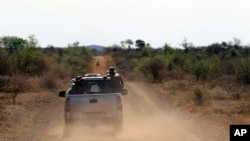FILE - Anti-rhino poaching troops simulate a hunt for poachers in the Madikwe Game Reserve, Botswana, Nov. 8, 2013.