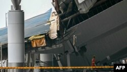 A member of the National Disaster Response Force works at the site of a collapsed terminal roof at Indira Gandhi International Airport after heavy rains in New Delhi, India, on June 28, 2024.