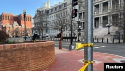 Police tape remains at the scene of an overnight shooting on a street bordering the White House complex, after Secret Service say they shot a man brandishing a firearm in Washington, March 9, 2025. 