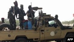 FILE - Soldiers of the Chad Army sit on the back of a Land Cruiser at the Koundoul market, 25 km from N'Djamena, Jan. 3, 2020, upon their return after a months-long mission fighting Boko Haram in neighboring Nigeria.