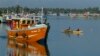  Lankan fishermen stand on a fishing vessel as it leaves a fishery harbor in Negombo, Negombo, outskirts of Colombo, Sri Lanka, Wednesday, Oct.15, 2014. In its fight against illegal fishing activities worldwide, the European Commissioner for Maritime Affa