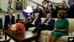 President Donald Trump speaks to, from left, Senate Majority Leader Mitch McConnell, R-Ky., Senate Minority Leader Chuck Schumer, D-N.Y., and House Minority Leader Nancy Pelosi, D-Calif., during a meeting with Congressional leaders in the Oval Office of the White House in Washington, Sept. 6, 2017.