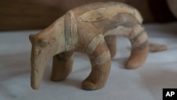 A Karaja culture ceramic depicting an armadillo rescued from the ashes of the fire that swept through Rio’s National Museum in September, is displayed during a media presentation, in Rio de Janeiro, Brazil, Dec. 10, 2018.