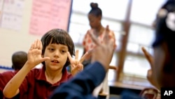 FILE - In this 2013 photo, a second grader works through a math lesson as part of Atlanta Public School's after-school remediation program.