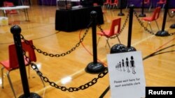 A sign for voters is seen in a polling area ahead of Election Day at the Waterville Junior High School in Waterville, Maine, Nov. 2, 2020.