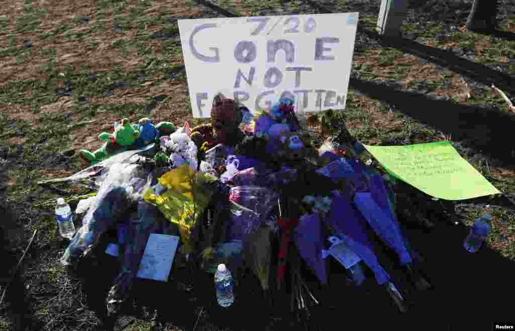 A memorial of flowers is set up for victims on a hillside behind the theater where a gunman opened fire on moviegoers in Aurora, Colorado July 21, 2012.
