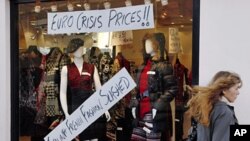 A pedestrian passes a shop in Brighton southern England, December 15, 2011