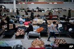 FILE - Ukrainian refugees rest at a refugee center in Nadarzyn, near Warsaw, Poland, Feb. 14, 2023.