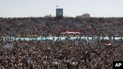 A large portrait of Yemen's President Ali Abdullah Saleh is seen as supporters gather at a soccer stadium for Saleh to speak in Sanaa March 10, 2011
