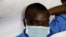 A mock coronavirus patient waits to be transported during an exercise simulating the treatment of a large number of coronavirus patients at the Aga Khan University Hospital in Nairobi, Kenya, April 9, 2020. 
