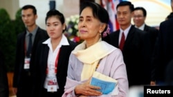 FILE - Myanmar State Counselor Aung San Suu Kyi walks between meetings at the ASEAN Summit in Vientiane, Laos Sept. 6, 2016. 