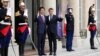 French President Emmanuel Macron, center right, and Japan's Prime Minister Shinzo Abe wave before their talks at the Elysee Palace, in Paris, April 23, 2019.
