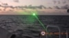 A green light appears from the direction of a Chinese coast guard ship at the Second Thomas Shoal, 105 nautical miles off the Palawan Province, Philippines, February 6, 2023 in this handout image. Philippine Coast Guard/Handout via REUTERS