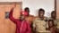 Opposition figurehead Robert Kyagulanyi, aka Bobi Wine, lifts his hand in the dock in the court room in Kampala, April 29, 2019. 