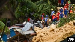 Rescuers search for survivors at the landslide site in Naga City, on the popular tourist island of Cebu, Sept. 20, 2018. At least three people were killed and 10 homes buried early Thursday in the central Philippines when heavy monsoon rains unleashed a landslide in a rural farming community, authorities said.