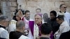 Latin Patriarch of Jerusalem Fouad Twal, center, arrives at the Church of the Nativity, built atop the site where Christians believe Jesus Christ was born, on Christmas Eve, in the West Bank City of Bethlehem, Thursday, Dec. 24, 2015.