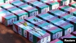 Coffins of casualties of the Islamic State attacks in Kerman, Iran, lie during a funeral ceremony in Kerman on Jan. 5, 2024. (West Asia News Agency via Reuters) 