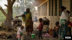 FILE - Families of refugees prepare injera, a traditional Ethiopian food, in the yard of one of many schools in Mekelle, Ethiopia, that are now camps for displaced families, June 3, 2021.