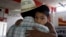 FILE - Miguel, 3, clings to his father, Miguel, an undocumented migrant, in San Juan, Texas, Aug. 27, 2010. Miguel and his wife, who remain in the U.S. as undocumented migrants, have two children born in the U.S. 