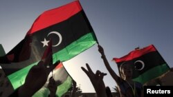 Libyans celebrate on the streets in Tripoli's Martyrs' Square after casting their vote during the National Assembly election, July 7, 2012. 