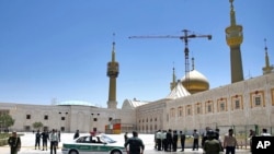 Police officers patrol the scene, around the shrine of late Iranian revolutionary founder Ayatollah Khomeini, after an attack by several perpetrators in Tehran, Iran, June 7, 2017.