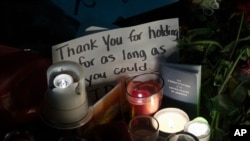 Candles and messages are left on the sidewalk in front of the Supreme Court to honor the late Justice Ruth Bader Ginsburg, in Washington, Sept. 19, 2020.