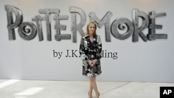 British author J.K. Rowling poses for photographers as she announces her new website project Pottermore at the Victoria and Albert Museum in London, June 23, 2011