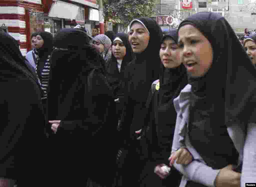 Friends of one of the soccer fans killed on Sunday mourn during the funeral, in Cairo, Feb. 9, 2015.